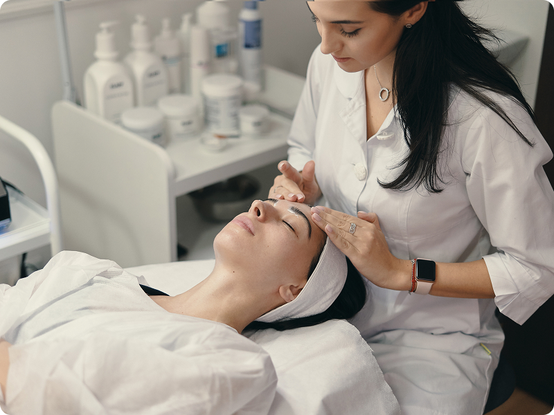 Patient receiving a facial skin consultation from a dermatologist.