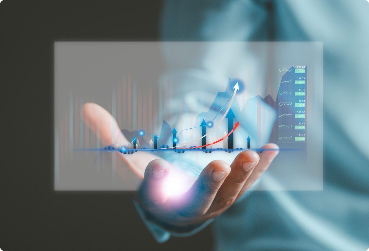 A hand holding a glowing digital holographic display showing rising bar charts and upward-trending line graphs.