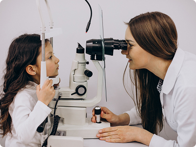 An ophthalmologist using a professional slit lamp microscope to perform a comprehensive eye exam on a young patient.